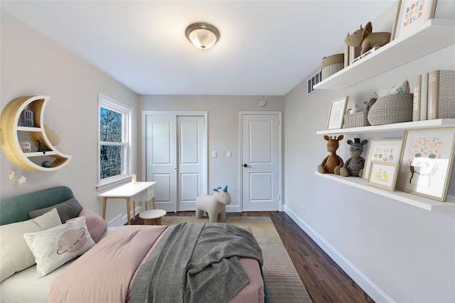 bedroom with a closet and dark hardwood / wood-style flooring