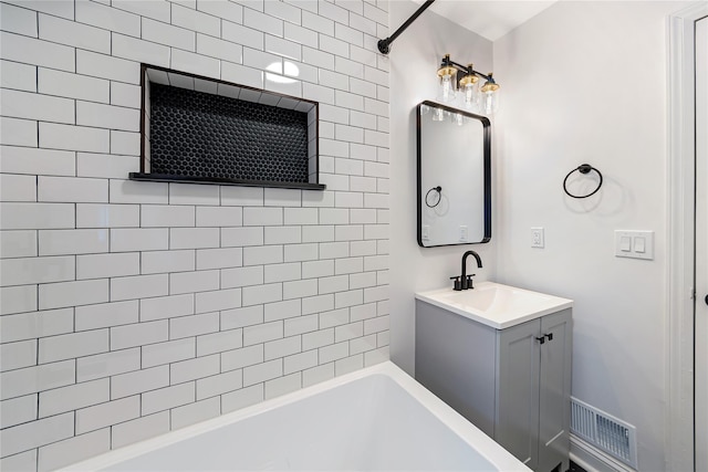 bathroom featuring vanity and tiled shower / bath