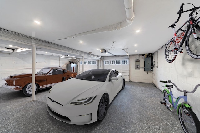 garage featuring electric panel, water heater, and a garage door opener