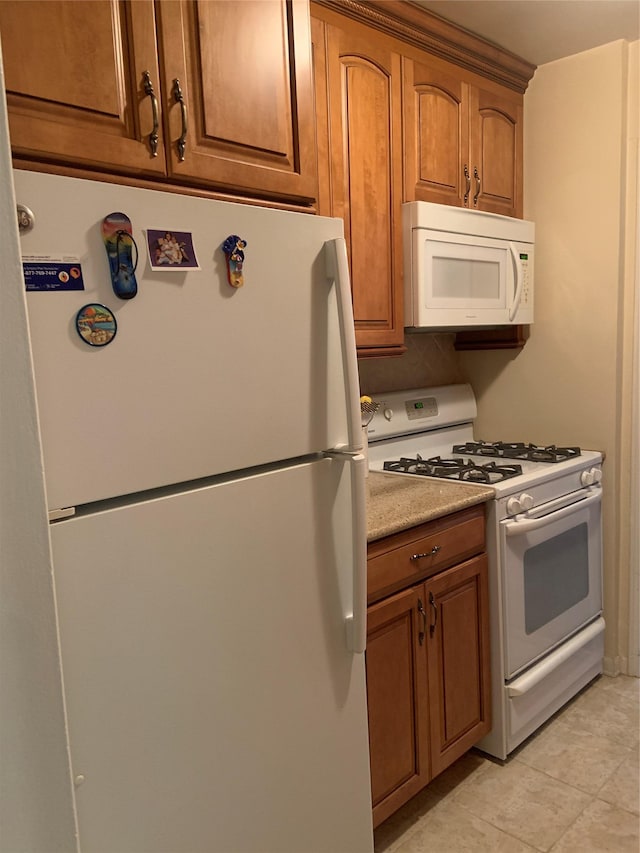 kitchen featuring white appliances and light tile patterned floors