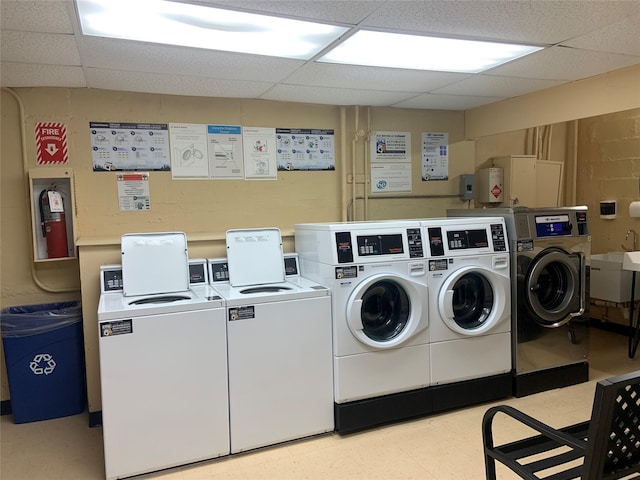 laundry area featuring washing machine and dryer and sink