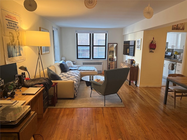 living room with radiator and light hardwood / wood-style floors