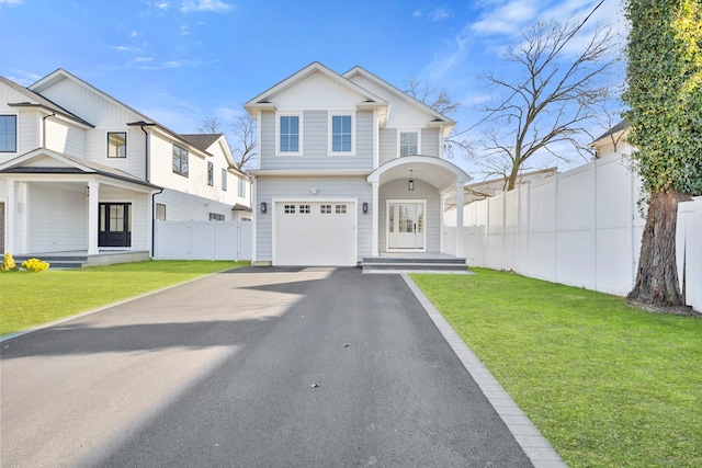 view of front of house with a garage and a front lawn