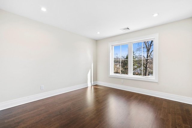 empty room with dark wood-type flooring