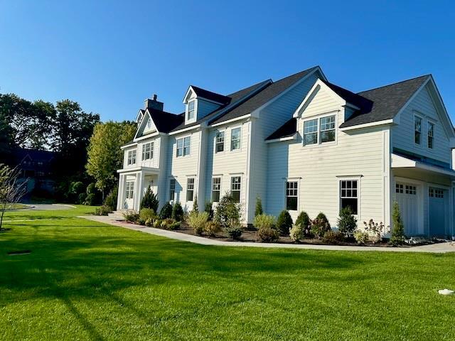 view of front of home featuring a garage and a front yard