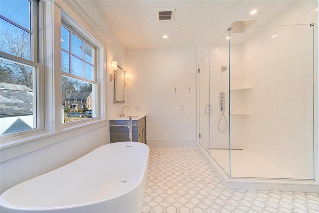 bathroom featuring a stall shower, visible vents, a soaking tub, vanity, and recessed lighting