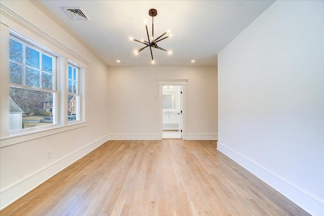 unfurnished room with baseboards, visible vents, light wood-type flooring, a chandelier, and recessed lighting