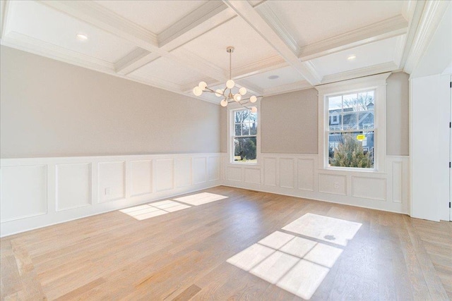 unfurnished room with light wood-style flooring, coffered ceiling, beam ceiling, and a notable chandelier