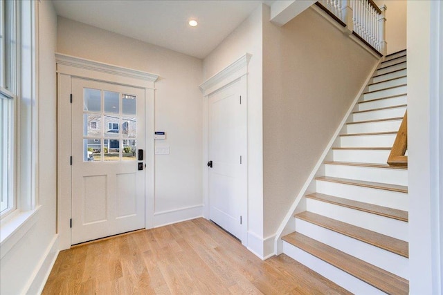 entryway with recessed lighting, stairway, light wood-type flooring, and baseboards