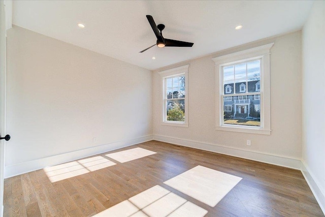 unfurnished room featuring ceiling fan, baseboards, wood finished floors, and recessed lighting