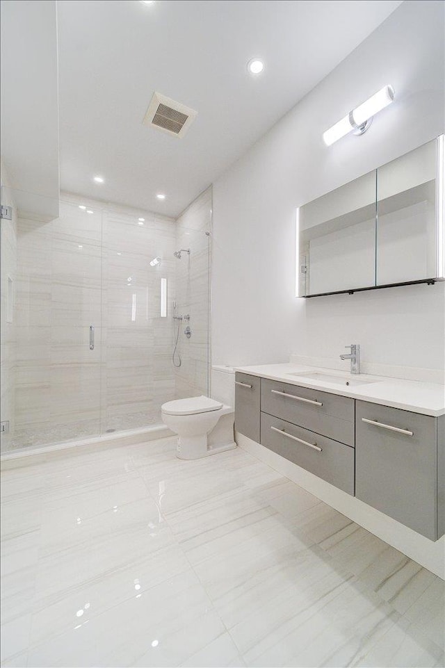 bathroom featuring toilet, a shower stall, visible vents, and vanity