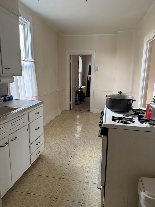 kitchen with white cabinetry and gas range oven