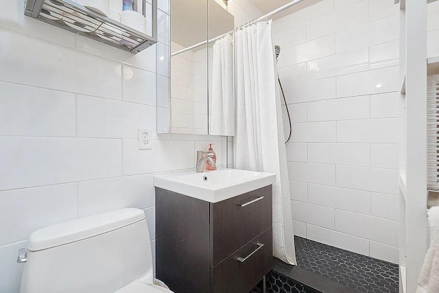 bathroom with toilet, vanity, and walk in shower