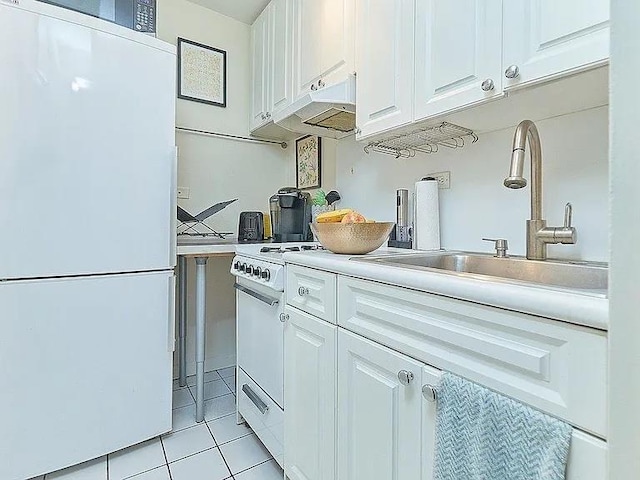 kitchen featuring sink, white appliances, white cabinets, and light tile patterned flooring