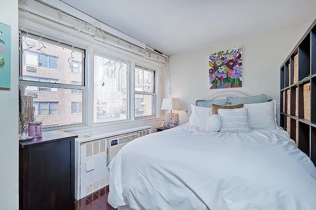 bedroom with dark hardwood / wood-style flooring