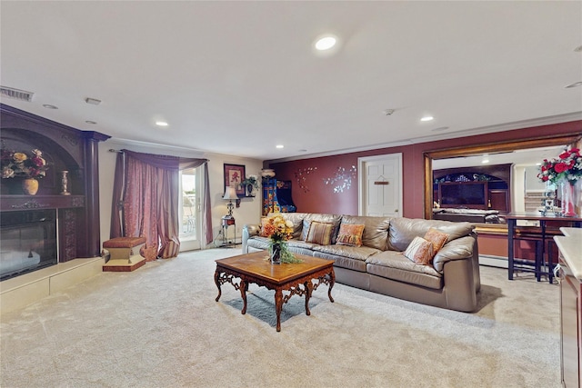 living room with light carpet, a tiled fireplace, and ornamental molding