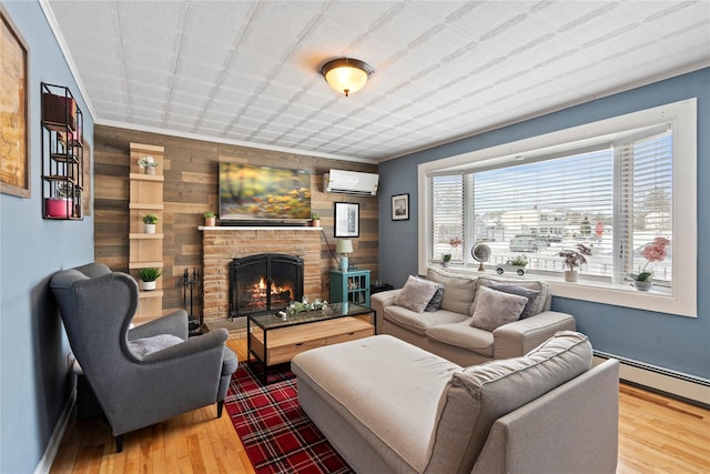 living room featuring a baseboard radiator, a wall mounted AC, a fireplace, hardwood / wood-style floors, and wooden walls