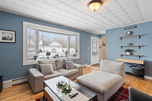 living room with light hardwood / wood-style floors and baseboard heating