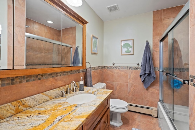 full bathroom with toilet, enclosed tub / shower combo, tile walls, a baseboard radiator, and tile patterned flooring