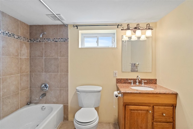 full bathroom featuring toilet, tiled shower / bath, tile patterned floors, and vanity