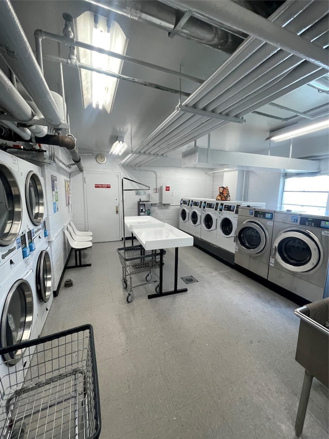 shared laundry area featuring tile patterned floors, washer and clothes dryer, and stacked washer and dryer