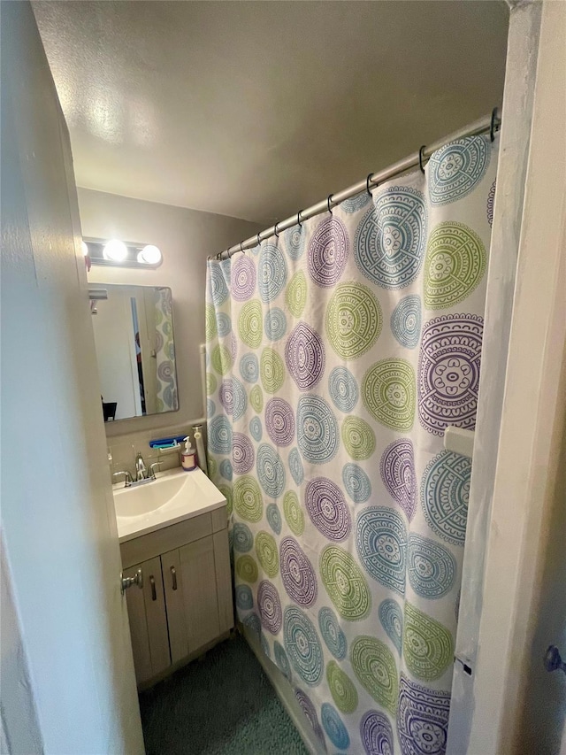 bathroom with vanity and a shower with shower curtain