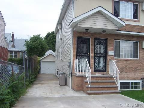 view of front of house with an outdoor structure and a garage