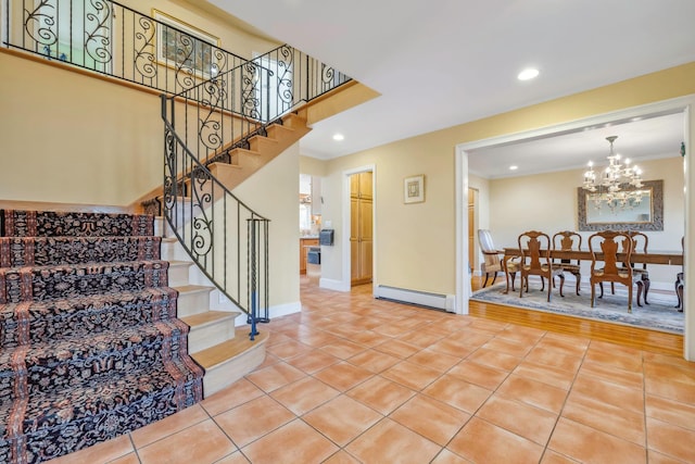 stairway featuring a baseboard radiator, an inviting chandelier, and tile patterned floors