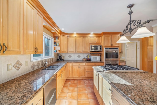 kitchen featuring decorative light fixtures, stainless steel appliances, dark stone countertops, tasteful backsplash, and sink