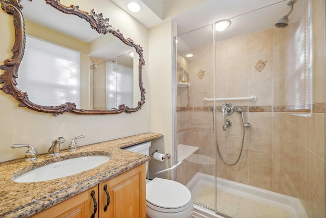 bathroom with vanity, toilet, and an enclosed shower