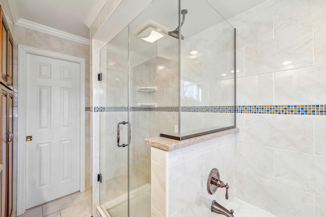 bathroom with a shower with shower door and crown molding