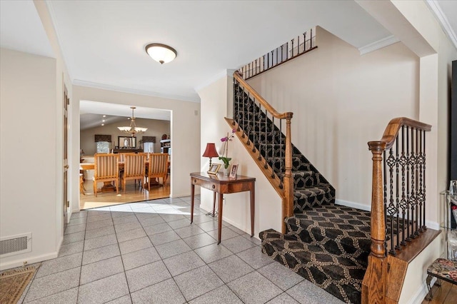 staircase featuring ornamental molding, lofted ceiling, and an inviting chandelier