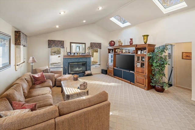 living room with a premium fireplace, lofted ceiling with skylight, and light colored carpet