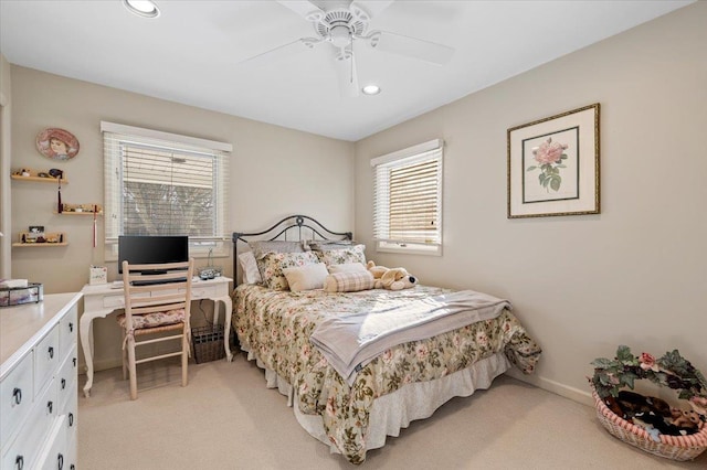 carpeted bedroom with multiple windows and ceiling fan