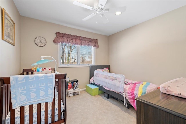 bedroom featuring ceiling fan and light carpet