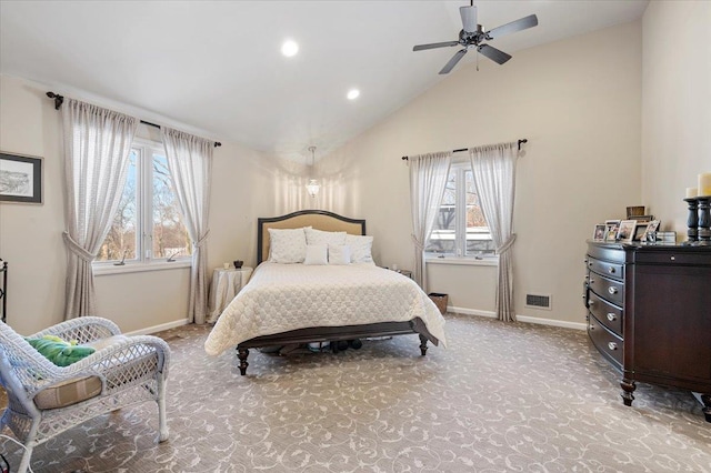 bedroom featuring multiple windows, vaulted ceiling, light carpet, and ceiling fan