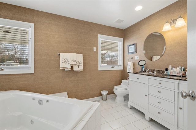 bathroom featuring a relaxing tiled tub, tile patterned floors, vanity, and toilet