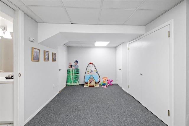 rec room featuring carpet and a drop ceiling