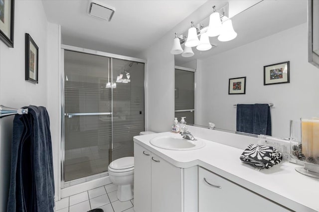 bathroom featuring tile patterned flooring, vanity, toilet, and an enclosed shower