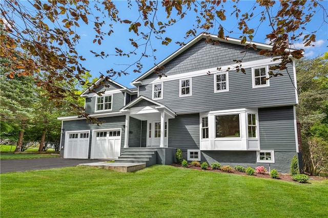 view of front of home featuring a garage and a front lawn