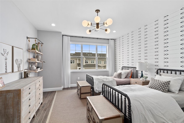 bedroom with an inviting chandelier and dark hardwood / wood-style floors