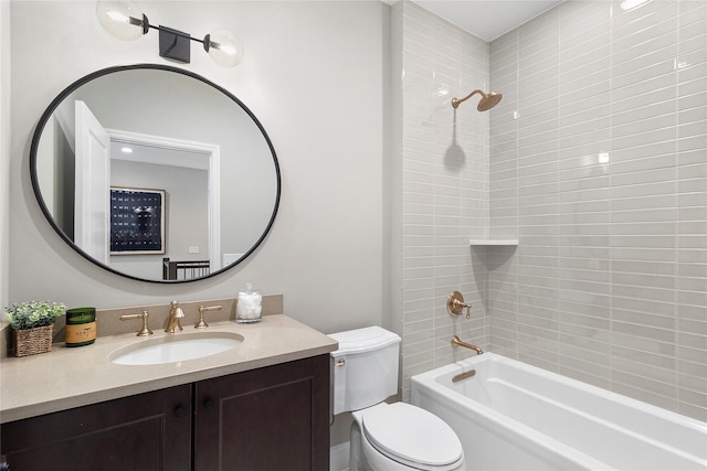 full bathroom featuring vanity, toilet, and tiled shower / bath