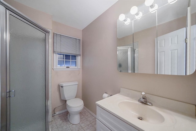 bathroom featuring vanity, tile patterned flooring, a shower with door, and toilet