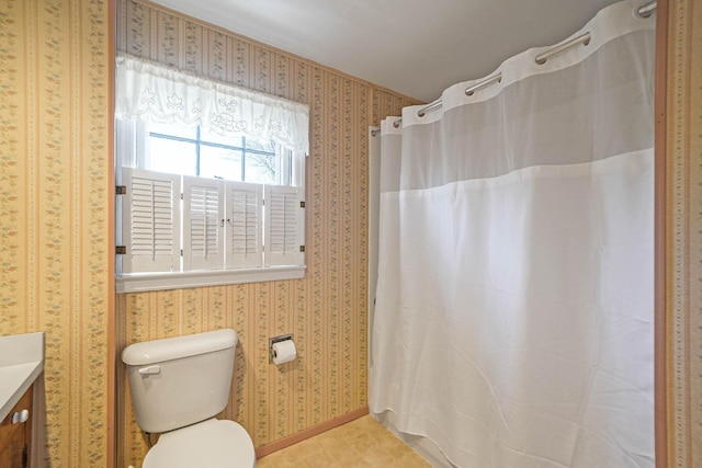 bathroom with walk in shower, vanity, and toilet