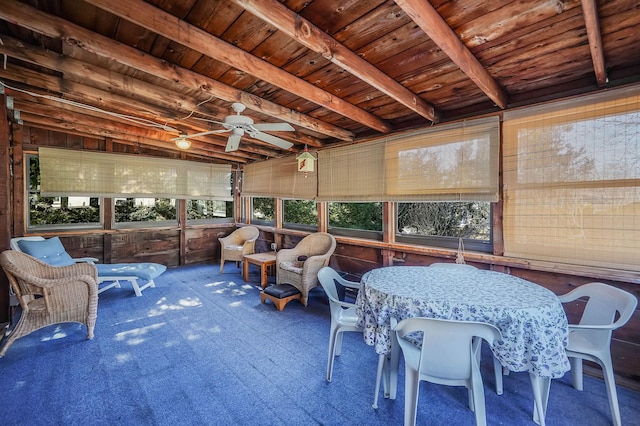 sunroom with beamed ceiling, wooden ceiling, and ceiling fan