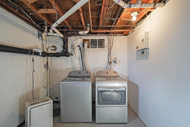 clothes washing area featuring washing machine and clothes dryer