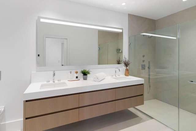 bathroom with vanity and a shower with door