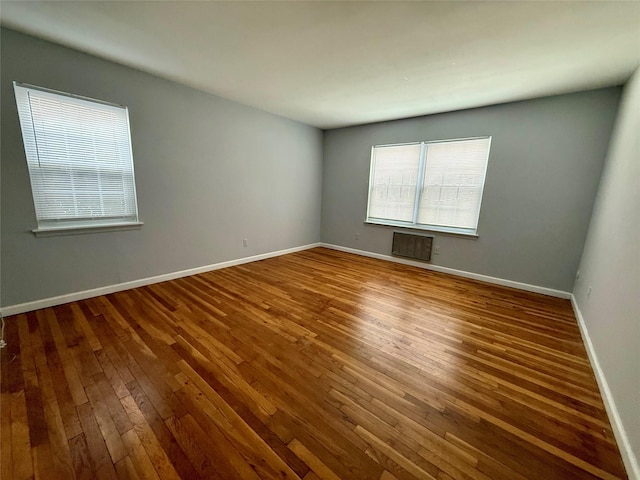 spare room with wood-type flooring