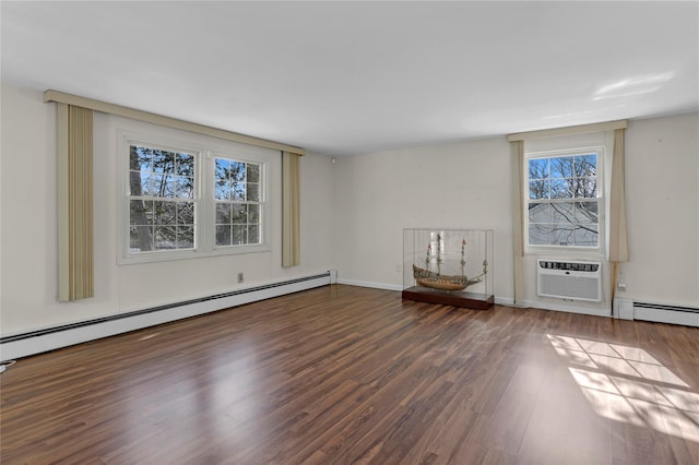 spare room featuring a wall mounted air conditioner, dark wood-type flooring, and a baseboard heating unit