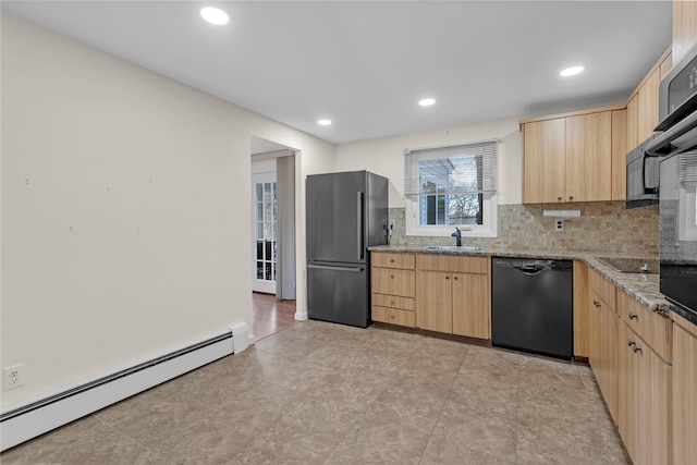 kitchen featuring light brown cabinetry, a baseboard radiator, light stone counters, black appliances, and sink